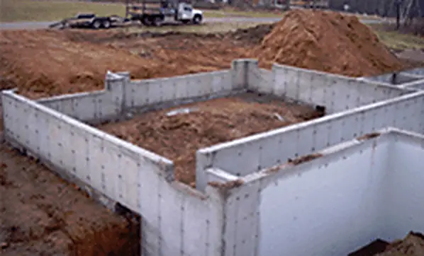 Newly poured concrete foundation walls on a Cloverbelt Construction job site